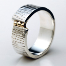 Textured silver ring with slight twist and 3 gold balls 