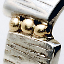 Textured silver ring with slight twist and 3 gold balls 