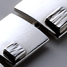 Graduated squares with smaller textured squares worn on a silver wire