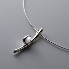 Oval mother of pearl pendant worn on a silver wire 