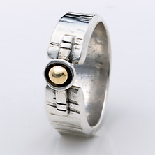 Textured band with gold ball set on a raised section of square wire 