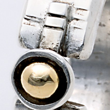 Textured band with gold ball set on a raised section of square wire 