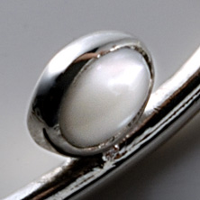 Oval mother of pearl pendant worn on a silver wire 