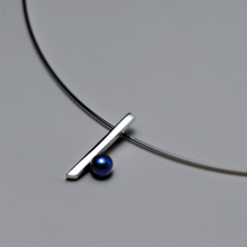 Silver bar pendant with black pearl worn on a silver wire 