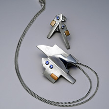 'Town piece' silver pendant in the style of a town house with gold detail and set stones 