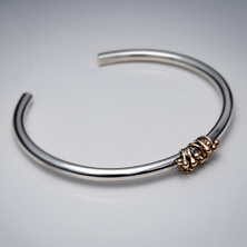 Heavy silver torque style bangle with gold wire detail 