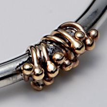 Heavy silver torque style bangle with gold wire detail 